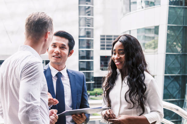 istock Group of business partners talking and working 909818854