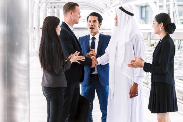 istock Successful businessmen handshake partner with arab businessman 909818926