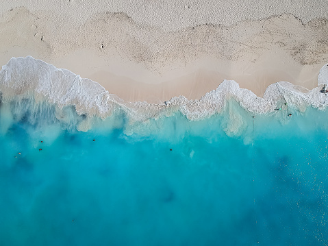 Drone photo of Grace Bay, Providenciales, Turks and Caicos. Only the caribbean blue sea and white sandy beaches can be seen