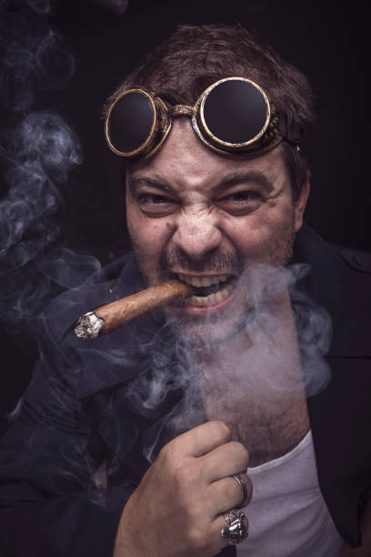 istock Steampunk smoker with a cuban cigar 909828664