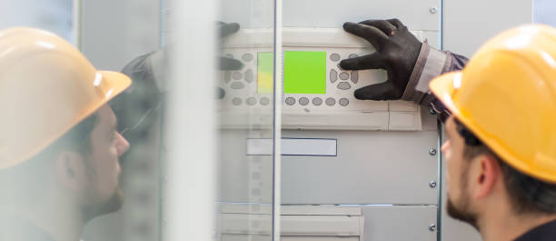 close up of maintenance engineer testing voltage switchgear - confined space safety danger sign imagens e fotografias de stock