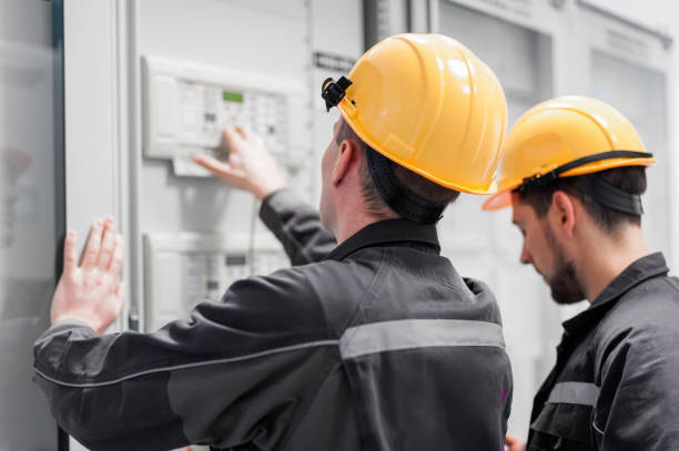 Field service crew testing electronics or inspecting electrical installation system Field service crew testing electronics or inspecting electrical installation system. Bay control unit. Medium voltage switchgear repairing electrical component stock pictures, royalty-free photos & images