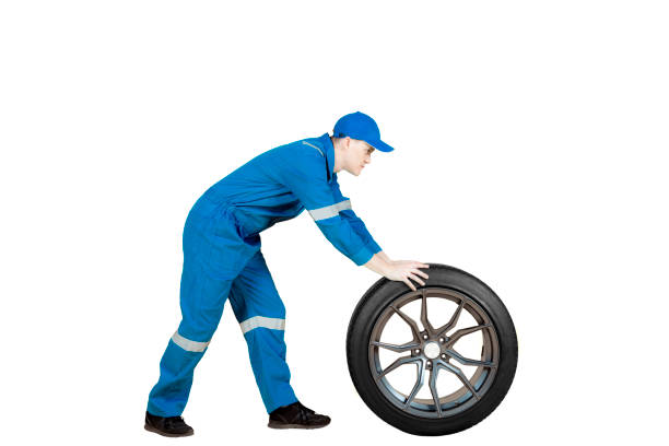 istock American mechanic pushing a car wheel on studio 909832452