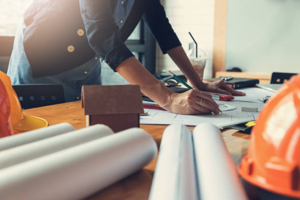istock Engineer and Architect concept, Engineer Architects office team working with blueprints, Vintage Effect 909835512