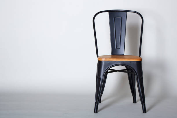 istock Steel with wood chair on Grey  textured background wall 909836162