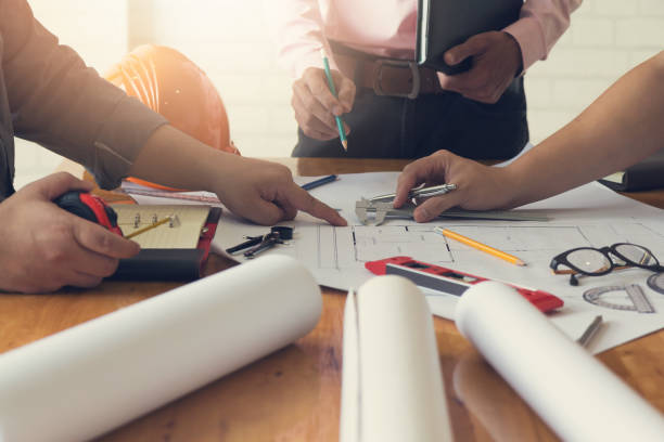 istock Engineer and Architect concept, Engineer Architects office team working with blueprints, Vintage Effect 909836902