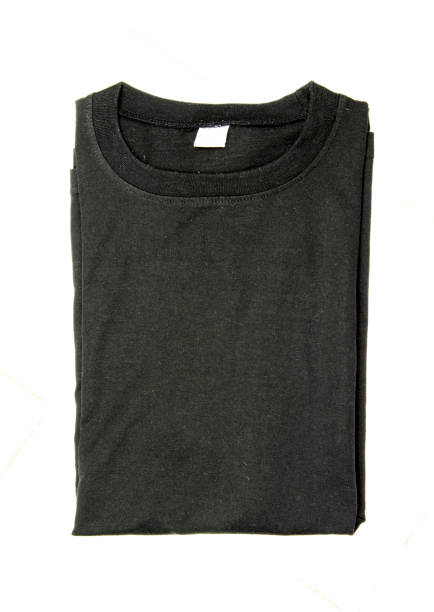 istock Black folded t-shirt isolated on white background 909839072