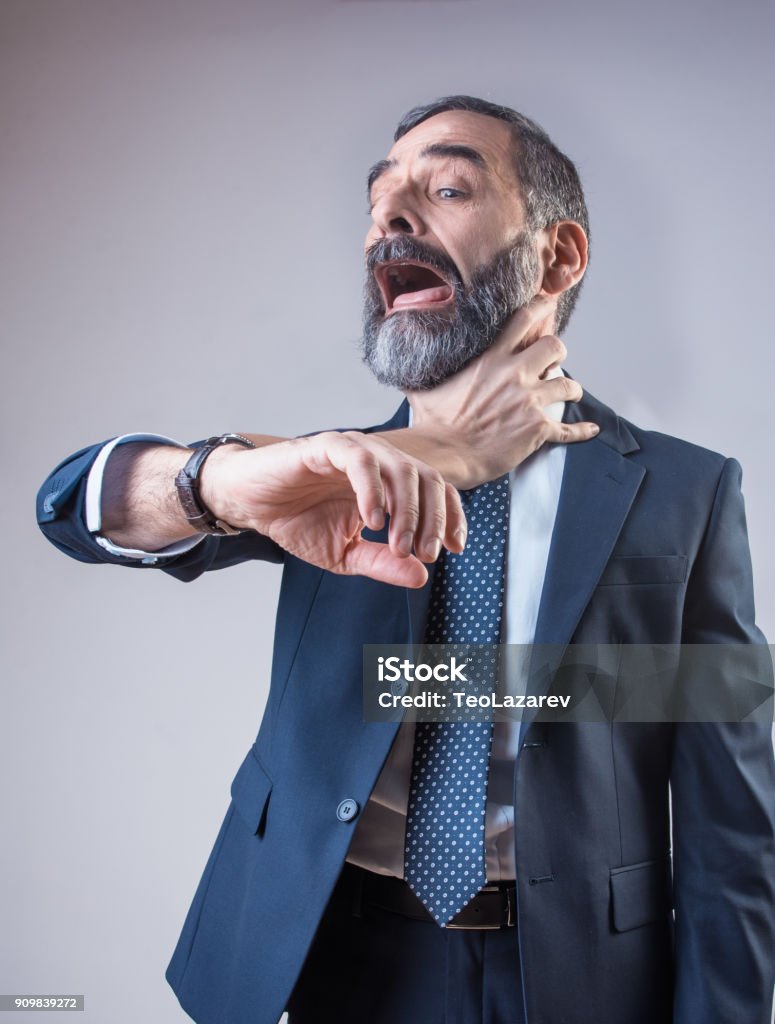 Wristwatch choking a senior business man Senior business man being choked by his wristwatch, deadline and time management concept Choking Stock Photo