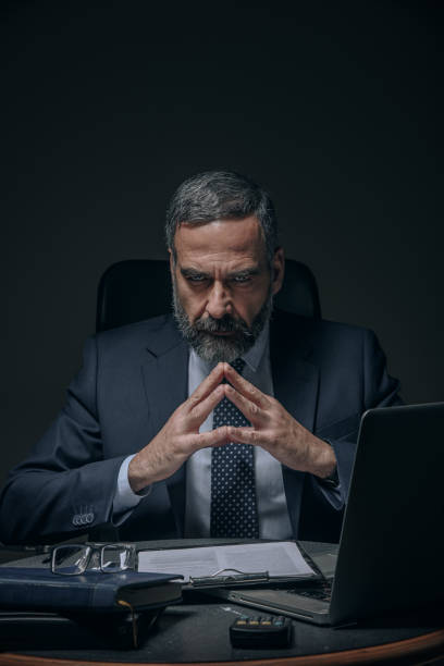 Evil senior business man Senior boss, evil corporate overlord in the dark foreperson stock pictures, royalty-free photos & images