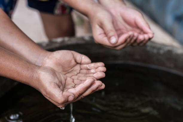 istock The hands of children who need water. 909839930