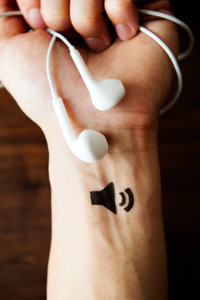 istock Hand holding headphones 909843174