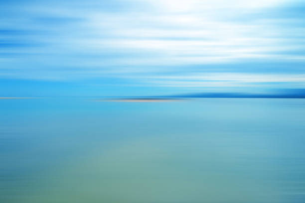 istock Motion blurred background of sky and the sea 909843804