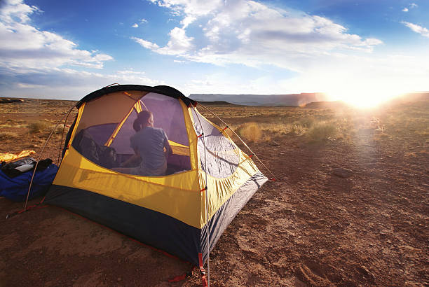 istock landscape camping sunset woman in tent 90984513