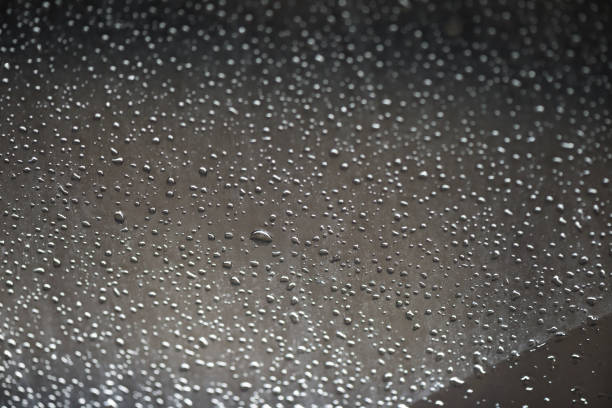 istock rain water drops on the window black color 909854152