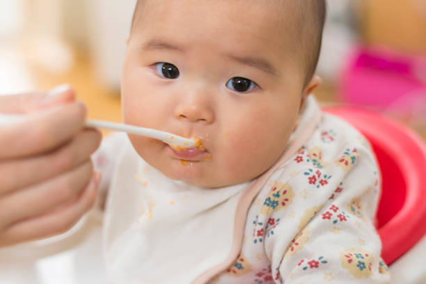 istock Baby eating a weaning food 909855448