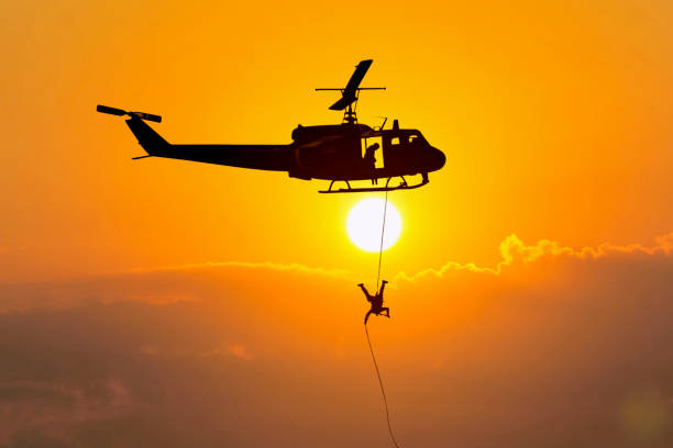 istock Soldiers rescue helicopter operations on sunset sky background 909855492