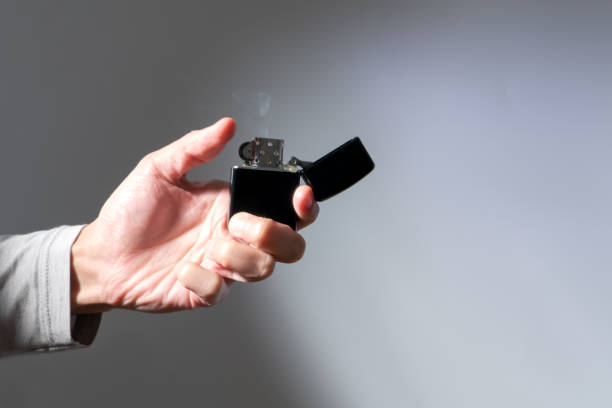 istock women hand hold the cigarette lighter, no fire lighter 909858890