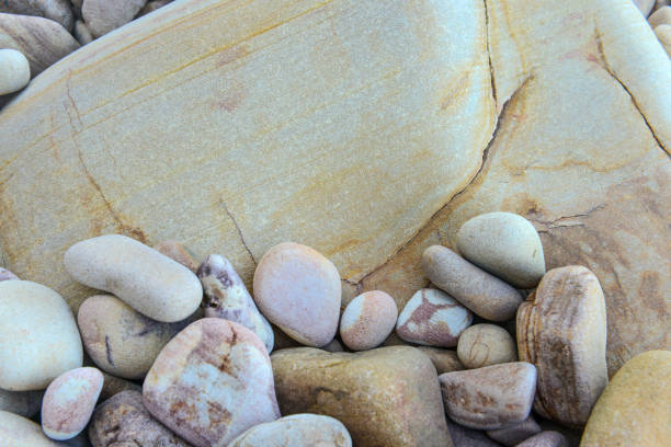 istock Close up of rounded and polished beach rocks 909861404