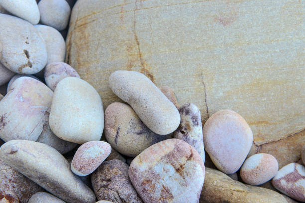 istock Close up of rounded and polished beach rocks 909861424
