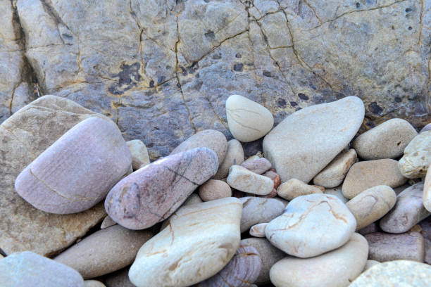 Close up of small rounded rocks on boulder background