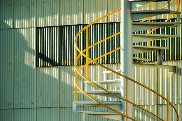 istock Stairs in an industrial area. Create geometric pattern with sunset. 909861900