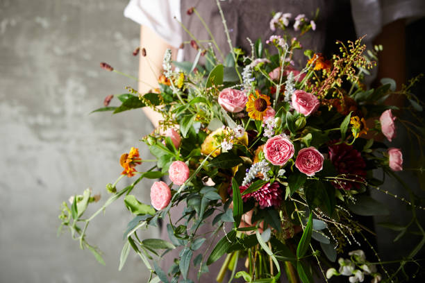 istock Woman holding flower bouquet 909862208