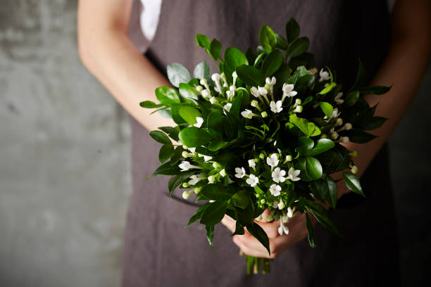 istock Woman holding flower 909862798