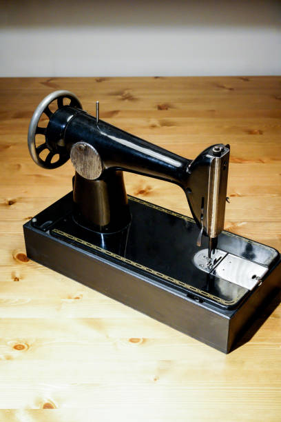 istock Vintage sewing machine on wooden table 909866986