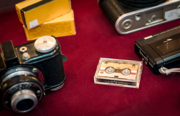 istock micro cassette tapes on red background around vintage items. 909867050