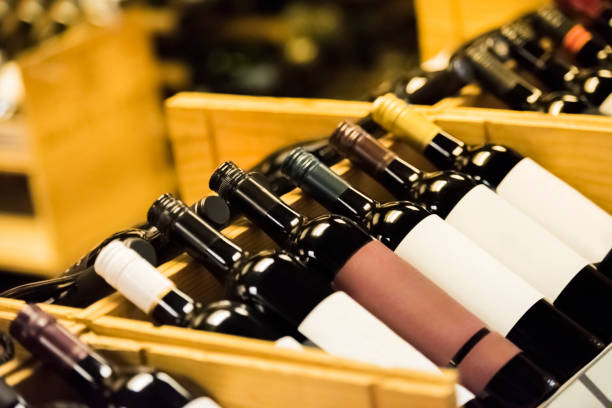 wooden wine rack with wine bottles - wine cellar liquor store wine rack imagens e fotografias de stock