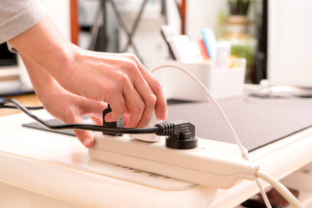 women hand putting the electric plug on the electricity supply connection - electric plug outlet human hand electricity imagens e fotografias de stock