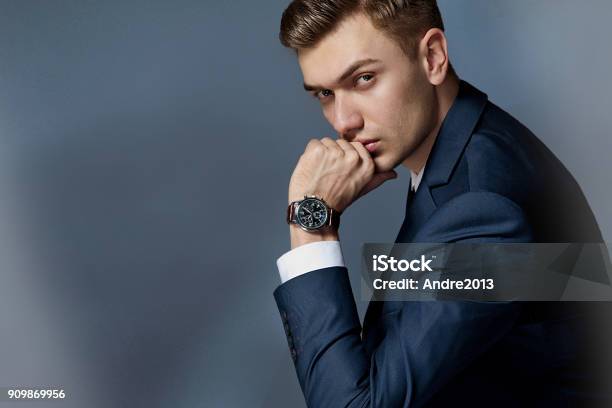 Portrait Of A Man Sitting With A Suit With A Watch Studio Stock Photo - Download Image Now