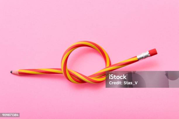 Flexible Pencil On A Pink Background Bent Pencils Twocolor Stock Photo - Download Image Now
