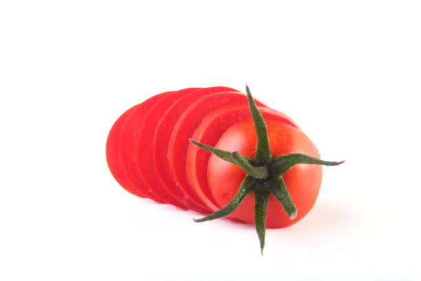 istock sliced fresh tomatoes with green leaves isolated on white background 909873768