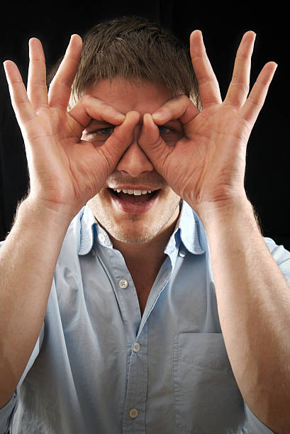 Men pretending to wear glasses.