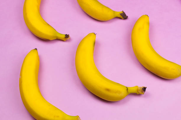 istock Bananas on pink pastel minimalism surface. 909874532