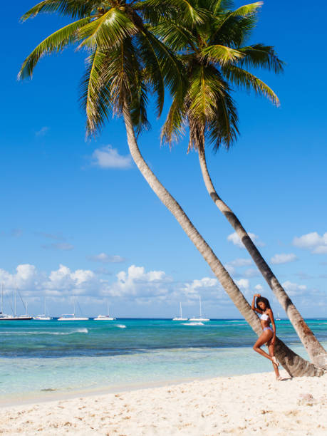 istock Leggy model posing on the Caribbean beach 909874610