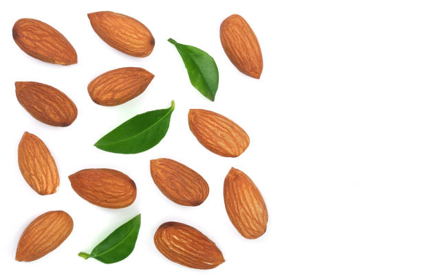 istock almonds with leaves isolated on white background with copy space for your text. Top view. Flat lay pattern 909877748
