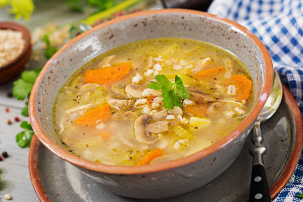 istock Thick soup with pearl barley, celery, chicken, and mushrooms. Dietary menu 909878712