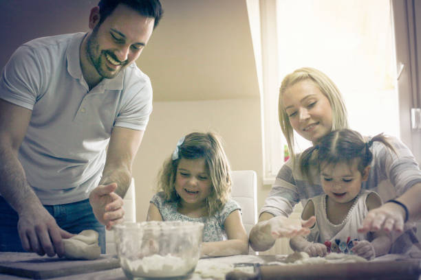istock Family making cookies in the kitchen. 909883092