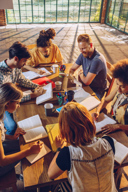 istock Above view of group of university students learning for their exams. 909883218