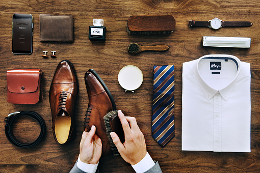 Businessman cleaning his shoes