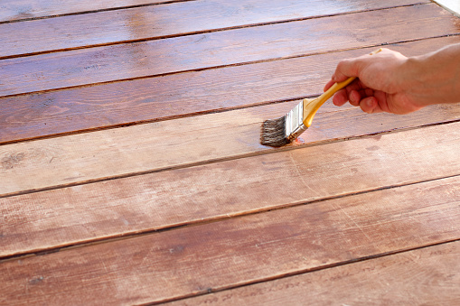 Hand use brush paint on wood surface