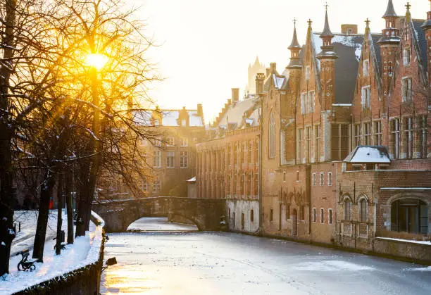 Townhouses and bridge reflected on the frozen Groenerei Canal at, Bruges, West Flanders province, Bruges,  Belgium