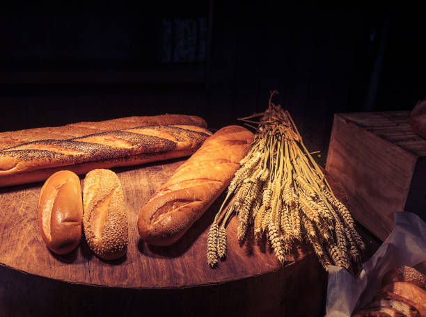 freshly homemade baked traditional bread on wooden table with dark background and copy space