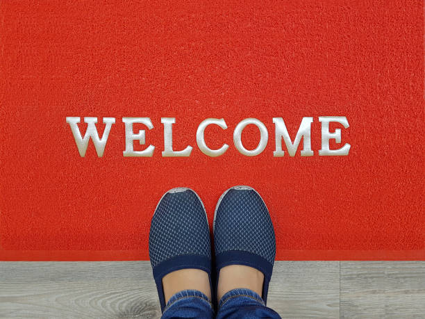istock red welcome carpet with foot-ware on it 909894666