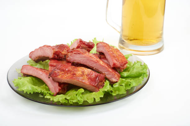 Roasted pork ribs and beer isolated on white background.