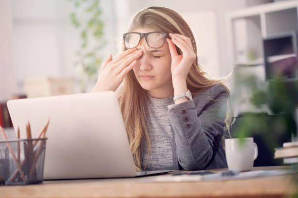 Young tired working woman at work Young tired working woman at work rubbing stock pictures, royalty-free photos & images