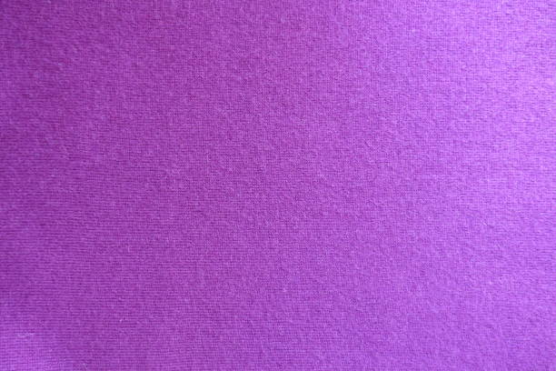 istock Surface of fuchsia colored knitted fabric from above 909909094