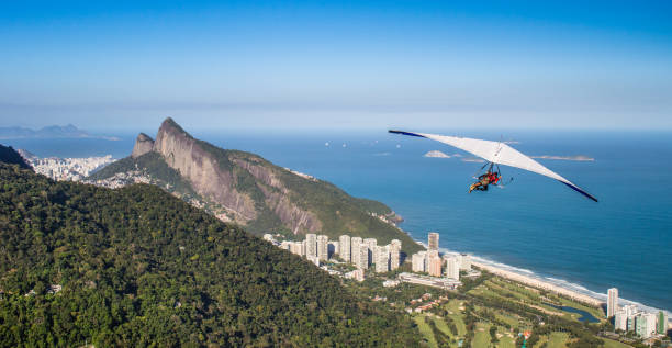 Hang gliding off Pedra Bonita is a popular thrill-seeking activity. Overlooking Rio de Janeiro, Brazi Rio de Janeiro, Brazil - August 4th, 2014: Hang gliding off Pedra Bonita is a popular thrill-seeking activity. Overlooking Rio de Janeiro, Brazil hang glider stock pictures, royalty-free photos & images